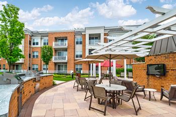 Outdoor patio with grilling area and dining spaces